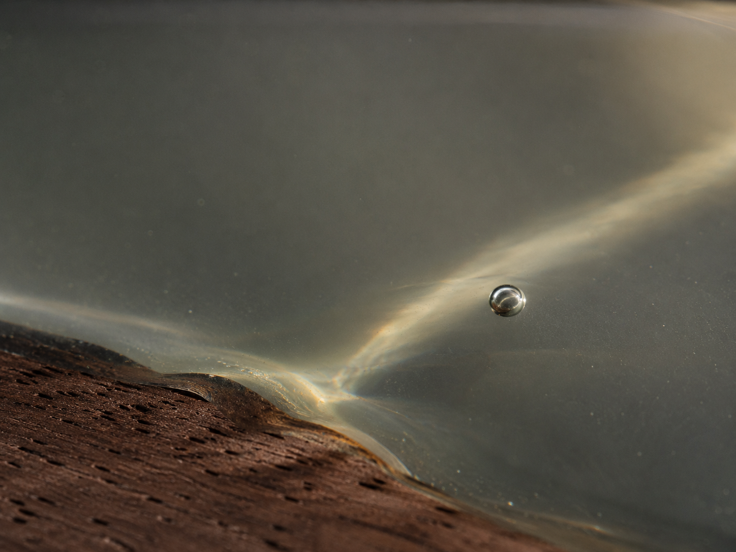 Clear resin gathering soft reflections and surrounding color