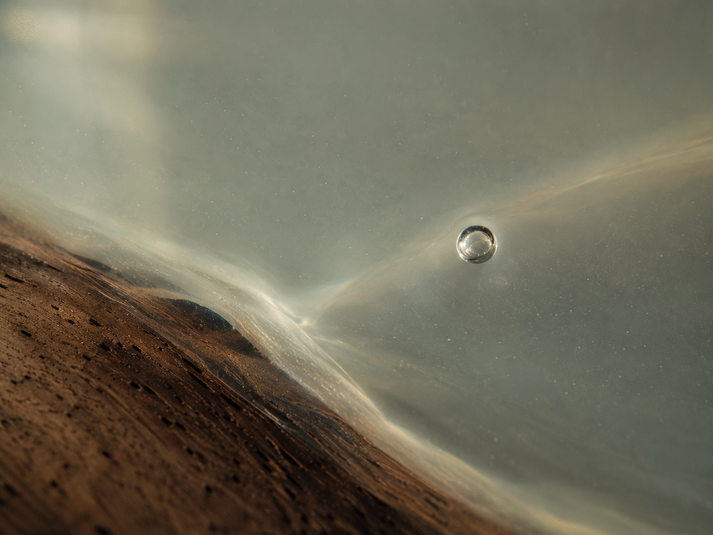 Close view through the depth of a clear resin surface